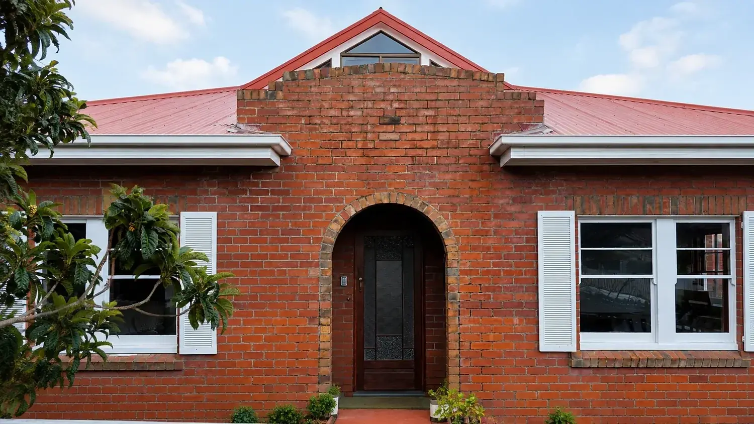 Brick Hobart home with timber windows, masonry walls and a metal roof.